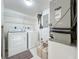 Functional laundry room with washer, dryer, and storage shelving at 1150 Carmel Cir # 301, Casselberry, FL 32707