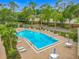 Community pool with lounge chairs and patio furniture at 1150 Carmel Cir # 301, Casselberry, FL 32707