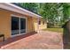 Back patio featuring brick pavers and a sliding glass door to the backyard at 1219 Helen St, Apopka, FL 32703