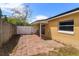 Back patio featuring a brick paver patio surrounded by a white wood fence at 1219 Helen St, Apopka, FL 32703