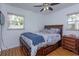Cozy bedroom featuring a dark wood bed frame, wood floors and bright natural light at 1219 Helen St, Apopka, FL 32703