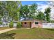 Charming single-story home with a covered parking area and well-maintained front lawn at 1219 Helen St, Apopka, FL 32703