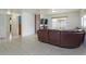 Open living room with tile flooring, ladder style shelving and a reclining leather sofa at 1219 Helen St, Apopka, FL 32703