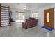 Bright living room with tile flooring, sliding glass doors, and natural wood door at 1219 Helen St, Apopka, FL 32703