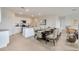 Open-concept kitchen and dining area with white cabinets and a large dining table at 1266 Limbali St, Mount Dora, FL 32757
