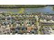 Aerial view of a home near a lake, surrounded by beautiful homes and lush landscape at 14720 Sweet Acacia Dr, Orlando, FL 32828