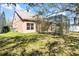 Exterior view of home's backyard featuring a lawn and screened in porch at 14720 Sweet Acacia Dr, Orlando, FL 32828