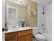 Well-lit bathroom featuring tiled shower, decorative painting, and plant at 14720 Sweet Acacia Dr, Orlando, FL 32828