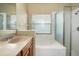 Bathroom featuring shower, tub and wood cabinets at 14720 Sweet Acacia Dr, Orlando, FL 32828