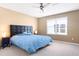 Bedroom featuring a black headboard, ceiling fan and window at 14720 Sweet Acacia Dr, Orlando, FL 32828