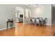 Open-concept dining area featuring hardwood floors, arched doorways, and seating for six at 14720 Sweet Acacia Dr, Orlando, FL 32828