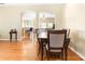 Inviting dining space showcasing hardwood floors, arched openings, and a table set for eight at 14720 Sweet Acacia Dr, Orlando, FL 32828