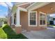 Inviting single-Gathering home featuring an attached carport with white pillars on a sunny day at 14720 Sweet Acacia Dr, Orlando, FL 32828