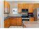 Kitchen boasts stainless steel appliances and wood cabinets, and provides great functionality for cooking at 14720 Sweet Acacia Dr, Orlando, FL 32828