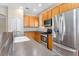 Kitchen boasts stainless steel appliances, wood cabinets, and neutral countertops, offering style and functionality at 14720 Sweet Acacia Dr, Orlando, FL 32828