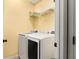 Laundry room equipped with a modern washer and dryer, with shelving for storage at 14720 Sweet Acacia Dr, Orlando, FL 32828