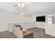 Cozy living room with neutral carpet and large TV at 14720 Sweet Acacia Dr, Orlando, FL 32828