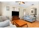 Comfortable living room featuring an entertainment center, hardwood floors, and modern décor at 14720 Sweet Acacia Dr, Orlando, FL 32828