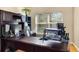 Spacious home office with a large desk, lots of storage, a comfortable chair, and natural light from the window at 14720 Sweet Acacia Dr, Orlando, FL 32828