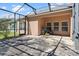 Covered screened-in porch with a grill, ideal for outdoor cooking and entertaining at 14720 Sweet Acacia Dr, Orlando, FL 32828