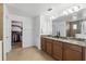 Bathroom featuring granite countertops, double sinks, and walk-in closet at 1558 Terra Verde Way, Ocoee, FL 34761