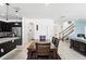 Open-concept dining area with dark cabinets, stainless steel appliances, and staircase at 1558 Terra Verde Way, Ocoee, FL 34761