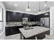Modern kitchen featuring granite countertops, stainless steel appliances, and dark wood cabinetry at 1558 Terra Verde Way, Ocoee, FL 34761