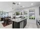 Bright kitchen with an island, granite countertops, and stainless appliances, open to the dining and living areas at 1558 Terra Verde Way, Ocoee, FL 34761