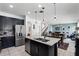 Modern kitchen with granite countertops, stainless steel appliances, and views into living and dining areas at 1558 Terra Verde Way, Ocoee, FL 34761