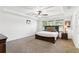 Main bedroom featuring a trey ceiling, a ceiling fan, carpeted floors, and a large window at 1558 Terra Verde Way, Ocoee, FL 34761