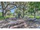 A playground with swings, slides, and picnic benches is shaded by large, mature trees at 1558 Terra Verde Way, Ocoee, FL 34761