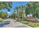 A tree-lined street leads to the stone sign of Arden Park under a sunny blue sky at 1558 Terra Verde Way, Ocoee, FL 34761