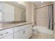 Bathroom features a vanity with white cabinets, tile flooring, and a shower with a bathtub at 15698 Marina Bay Dr, Winter Garden, FL 34787