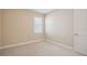 Bright bedroom with neutral carpet, baseboards and paint, and white doors at 15698 Marina Bay Dr, Winter Garden, FL 34787