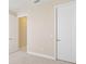 Bright bedroom with neutral carpet, baseboards and paint, and white doors at 15698 Marina Bay Dr, Winter Garden, FL 34787