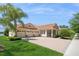 Elegant home featuring a three-car garage, red tile roof, and well-maintained landscaping with a palm tree at 15698 Marina Bay Dr, Winter Garden, FL 34787