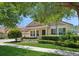 Charming single-story home with a manicured lawn, mature trees, and a paver driveway, radiating curb appeal at 15698 Marina Bay Dr, Winter Garden, FL 34787