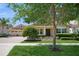 Charming single-story home with a manicured lawn, mature trees, and a paver driveway, radiating curb appeal at 15698 Marina Bay Dr, Winter Garden, FL 34787