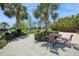 Community grilling area with outdoor seating, built-in grills, and shade trees near the lake at 15698 Marina Bay Dr, Winter Garden, FL 34787