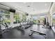 Bright gym with various exercise machines, ceiling fans, rubber floor, and large windows at 15698 Marina Bay Dr, Winter Garden, FL 34787