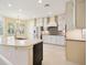 Open kitchen with stainless appliances, light cabinets and stone backsplash at 15698 Marina Bay Dr, Winter Garden, FL 34787