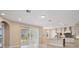 Open-concept kitchen and living room with stainless appliances, light cabinets, and waterfront views at 15698 Marina Bay Dr, Winter Garden, FL 34787