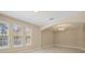 Bright living space featuring large windows, archway details, recessed lighting, and neutral walls at 15698 Marina Bay Dr, Winter Garden, FL 34787