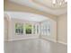 Spacious living area featuring tile flooring, archways, and natural light from large windows at 15698 Marina Bay Dr, Winter Garden, FL 34787