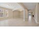 Bright, open living space with elegant archways, neutral tile flooring, and recessed lighting at 15698 Marina Bay Dr, Winter Garden, FL 34787