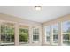 Bright living room featuring multiple large windows with natural light and neutral-colored walls at 15698 Marina Bay Dr, Winter Garden, FL 34787