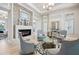 Cozy lounge area with fireplace, modern decor, comfortable chairs, and light wood floors at 15698 Marina Bay Dr, Winter Garden, FL 34787