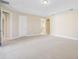 Expansive main bedroom with tray ceilings, neutral carpet, and easy access to bathroom and closet spaces at 15698 Marina Bay Dr, Winter Garden, FL 34787
