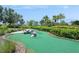 Outdoor mini golf green with palm trees and lush landscaping at 15698 Marina Bay Dr, Winter Garden, FL 34787