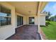 Covered patio featuring brick pavers, offering an outdoor living space at 15698 Marina Bay Dr, Winter Garden, FL 34787